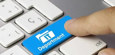 person pressing an 'IT Department' button on a computer keyboard