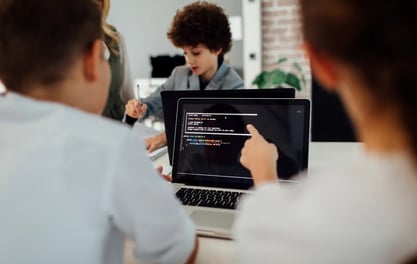 K-12 IT directors sitting at desks to discuss platforms and automations
