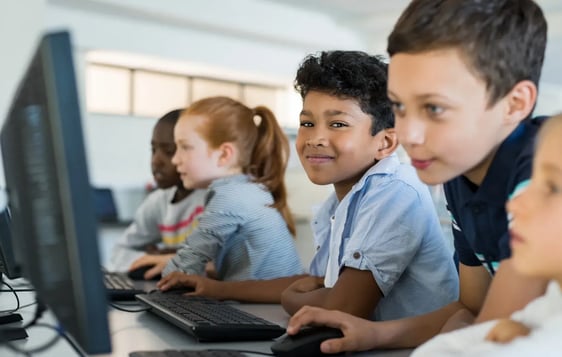 young students using the school computers during class for learning purposes